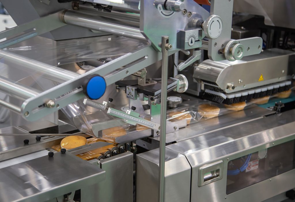 Bread, toast, bun plastic wrapping machine on bakery production line