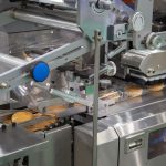 Bread, toast, bun plastic wrapping machine on bakery production line