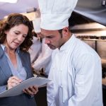 QC at restaurant kitchen standing with chef - Value of Sanitation Certification of Food Equipment | NSF
